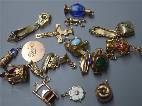 A 9ct gold crucifix pendant and a collection of nineteen 9ct gold charms, various,